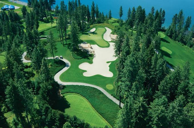 Aerial of a sculpted fairway and bunkers beside Lake Coeur d'Alene